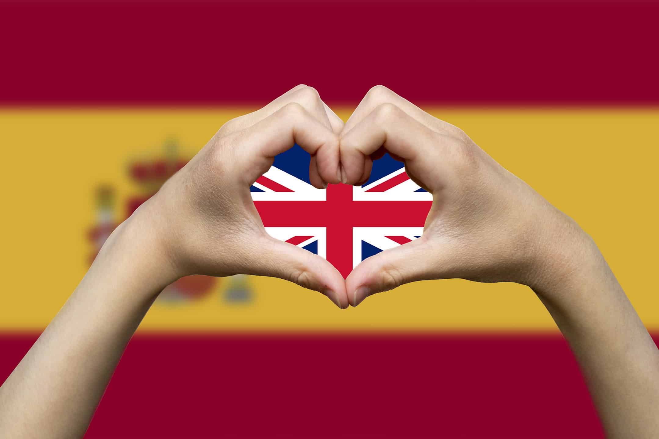 spain-flag-with-two-hands-heart-shape-hand-heart-love-sign-with Union Jack in the center.